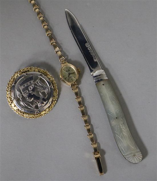 A ladys 9ct gold wrist watch, a brooch and a silver fruit knife.